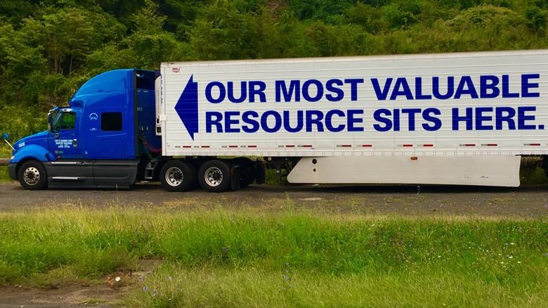 semi-truck on the road with an advertisement on the trailer