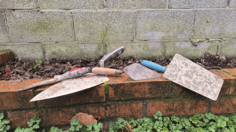 trowels on my brick flower bed