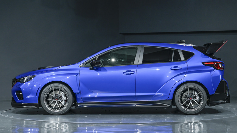 Side view of blue 2025 Subaru Performance-B STI concept parked in studio.