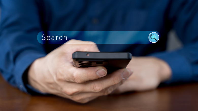 Person searching for information on smart phone