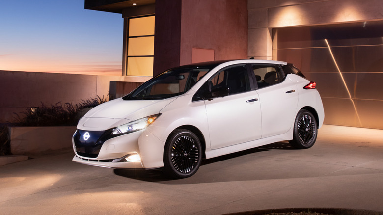 A white Nissan Leaf parked in a driveway