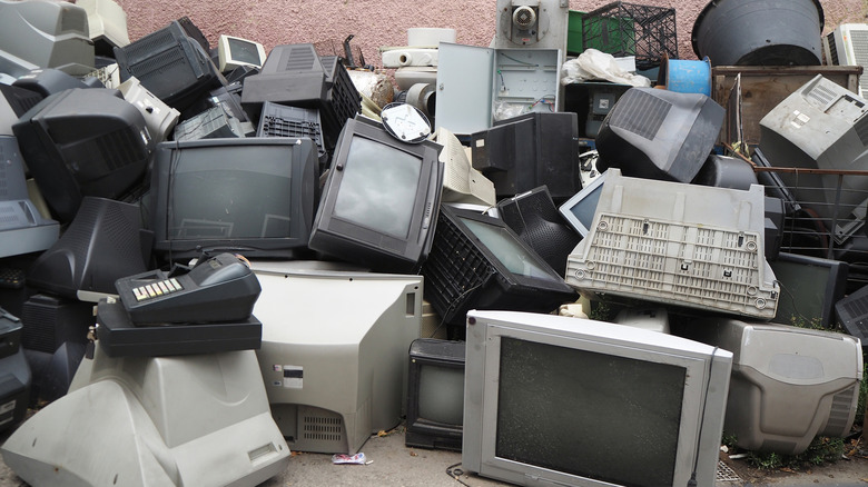 A pile of broken CRT TVs and other technology.