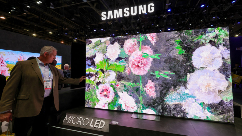 Man inspecting Samsung MicroLED TV at showroom