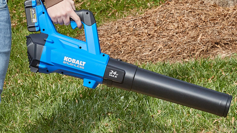 Hand holds Kobalt Brushless 24V Max to use in yard