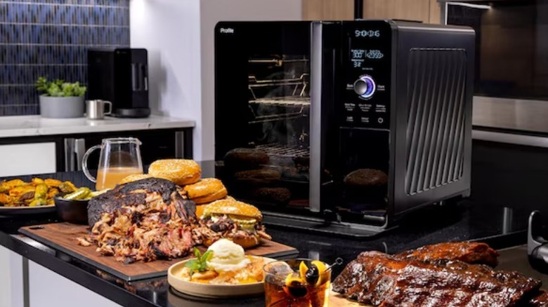 GE Profile Indoor Smart Electric Smoker on counter covered in smoked meats