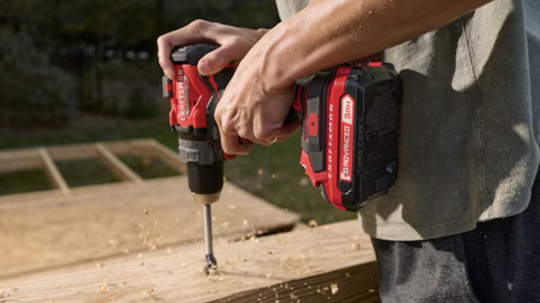 A man using a Craftsman drill with a V20 battery attached