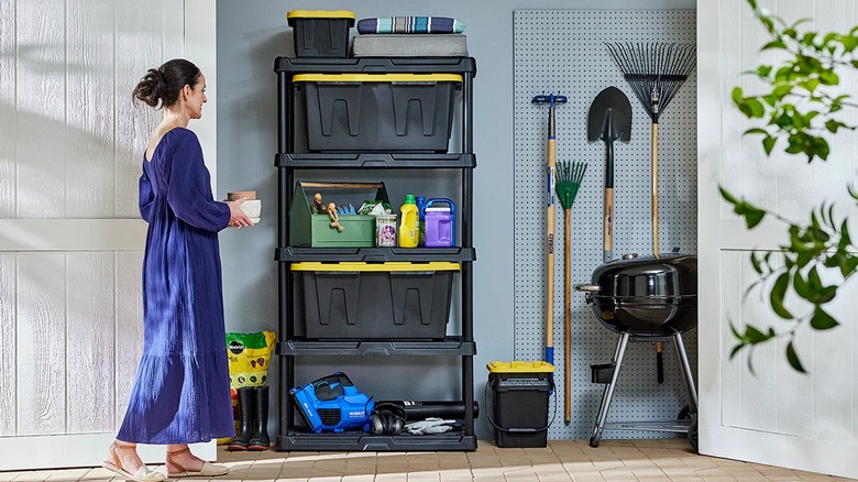 Woman walking towards the plastic shelving unit