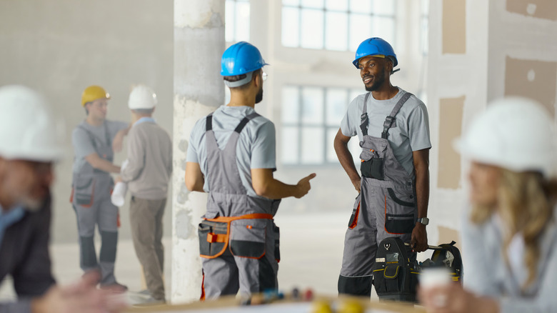 A group of construction workers at work inside a large room