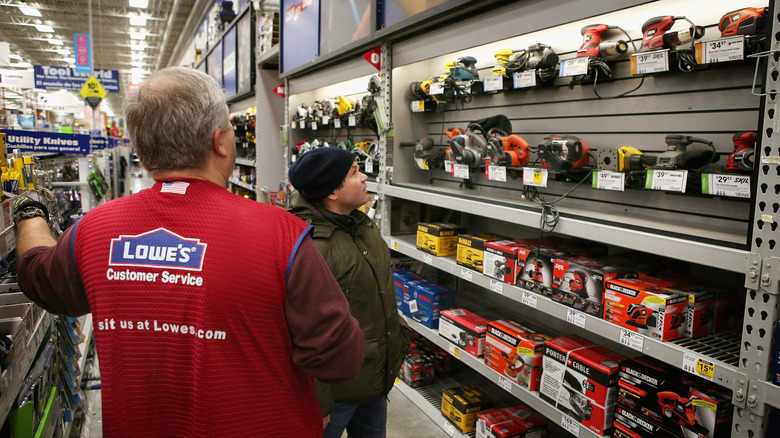 lowe's working helping customer in tool aisle
