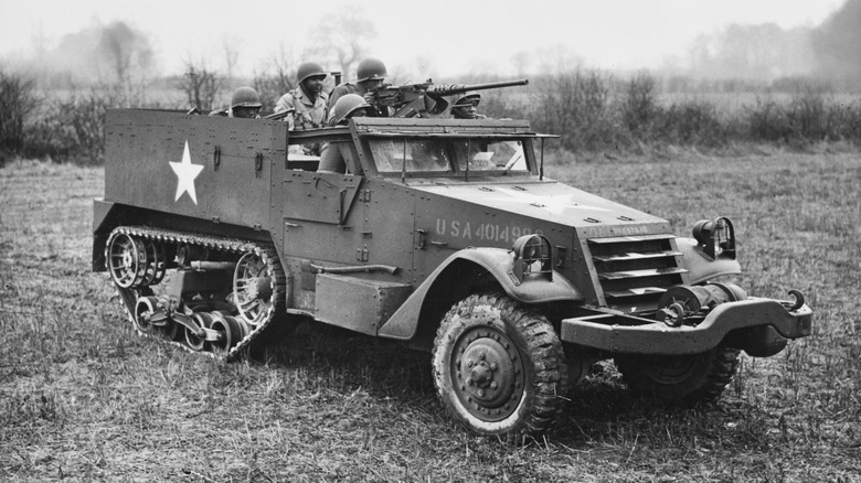 A group of soldiers on board an Army half track in WWII