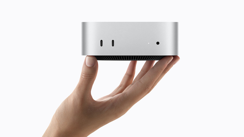 Person holding the M6 Mac mini in their hand