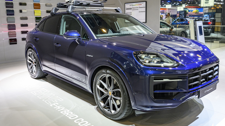 A blue Porsche Cayenne E-Hybrid Coupe on display