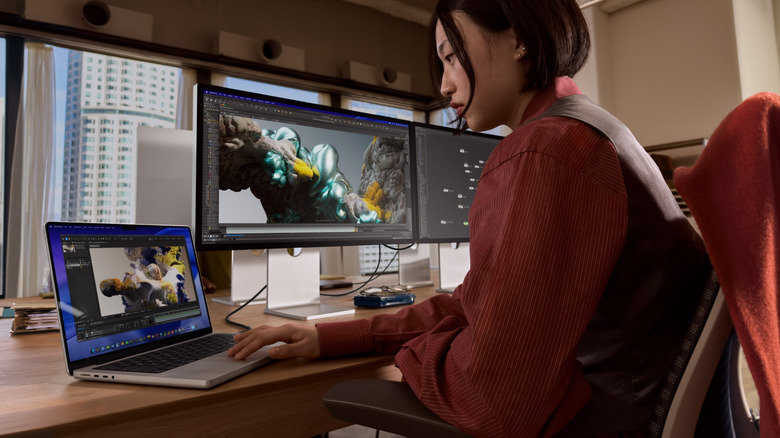 Person using a 2026 MacBook Pro on a workstation