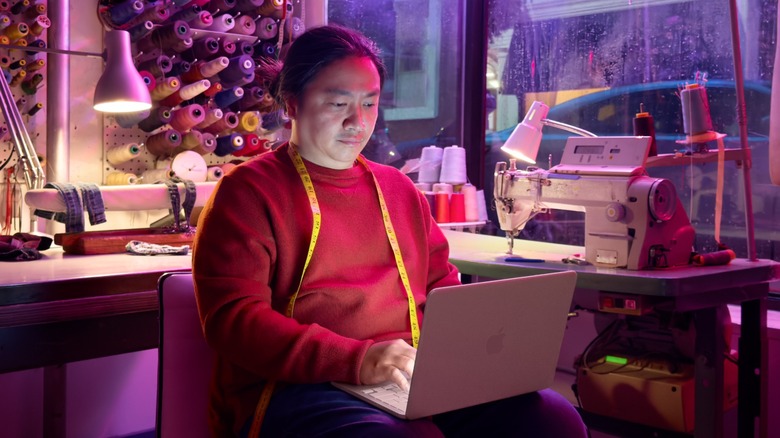 a tailor using the Apple MacBook Neo in their shop
