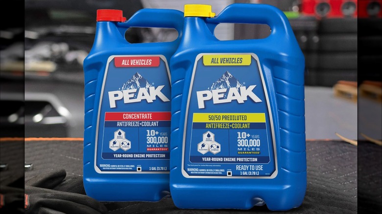 Two bottles of Peak antifreeze in a garage
