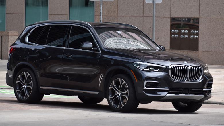 A black BMW X5 driving