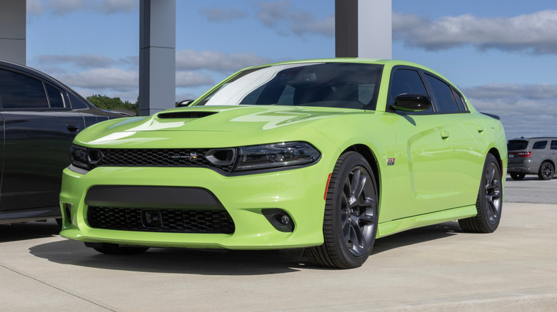 A green Dodge Charger parked