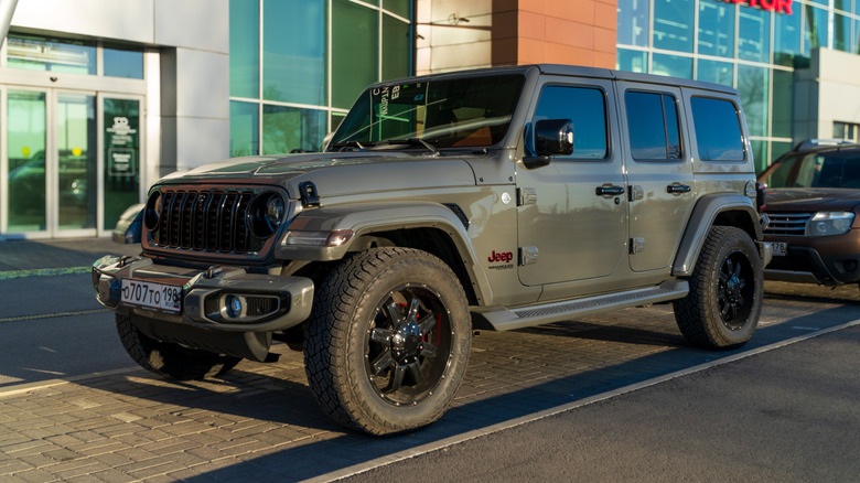 A gray Jeep Wrangler parked