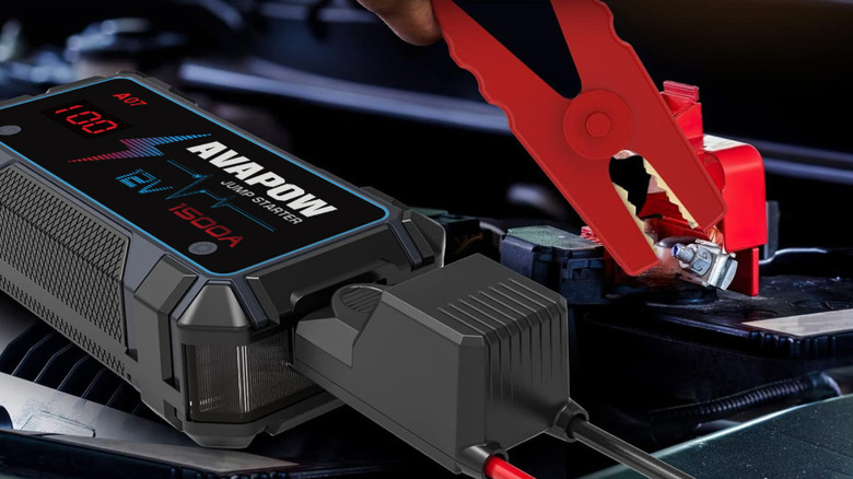 jump starter connected to battery with clamps