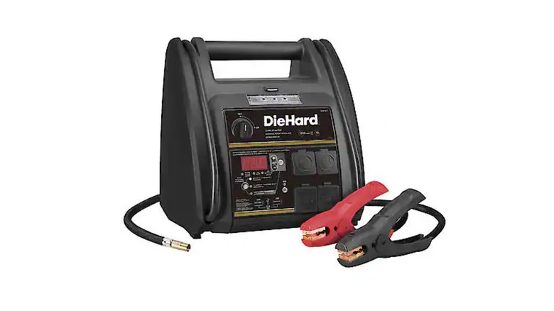 DieHard jump starter on a cart near a vehicle with hood open