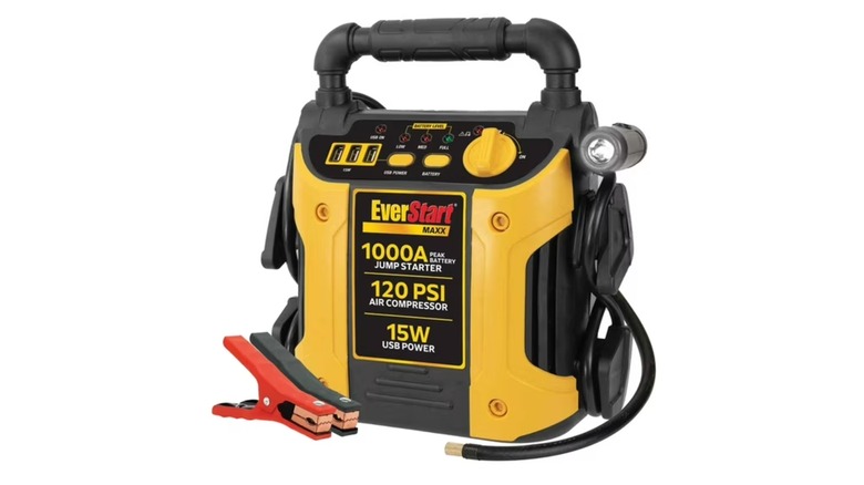 EverStart jump starter resting under a vehicle open hood