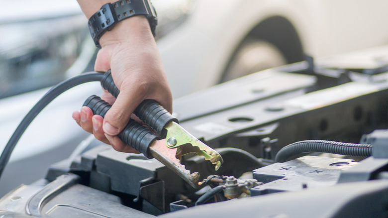 attaching jumper cables to battery