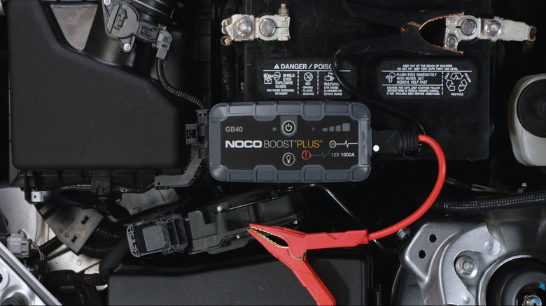 jump starter resting on a car battery