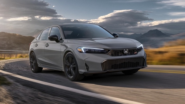 2026 Honda Civic Si driving, front 3/4 view, gray exterior