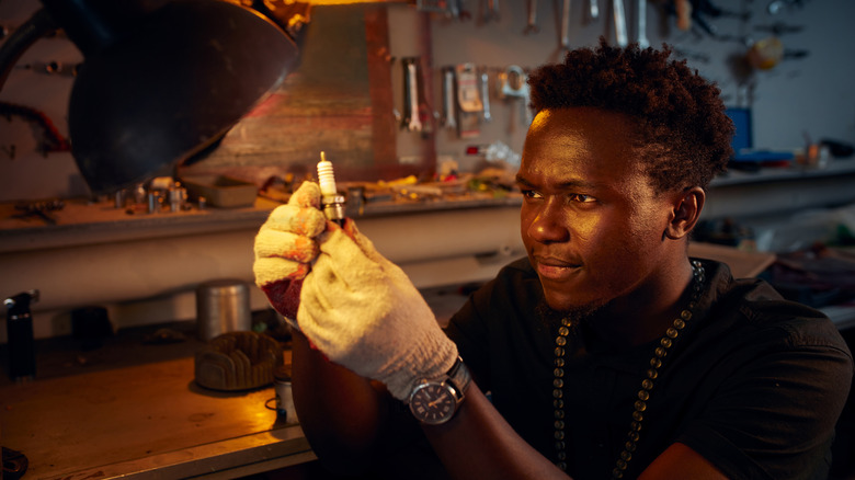 Man inspecting spark plug