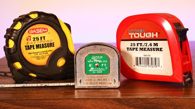 Three tape measures on a table near each other