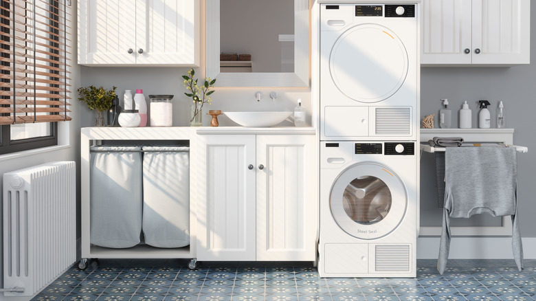 A washroom with a stacked washer and dryer