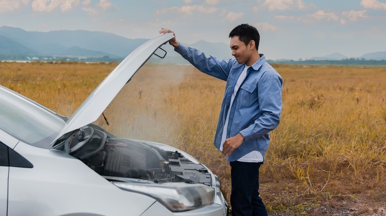 Holding hood of broken-down vehicle