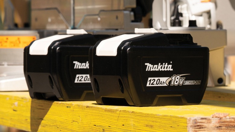 Two 12Ah Makita 18V batteries on a workbench.