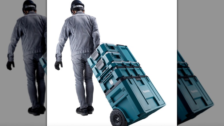 Worker pulling vertical MakTrak stack on a white background