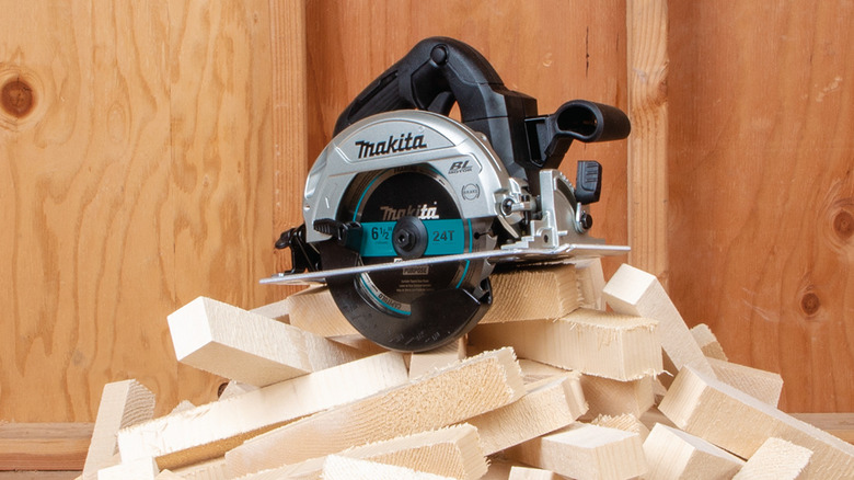 A Makita LXT Sub-Compact cordless 6-1/2-inch circular saw placed on a pile of freshly cut wood blocks