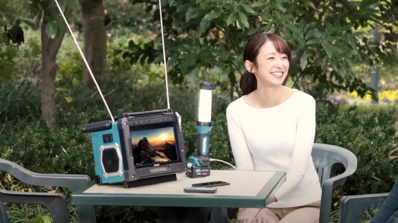 Woman using Makita rechargeable TV outside