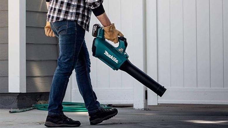 Person using Makita blower outside