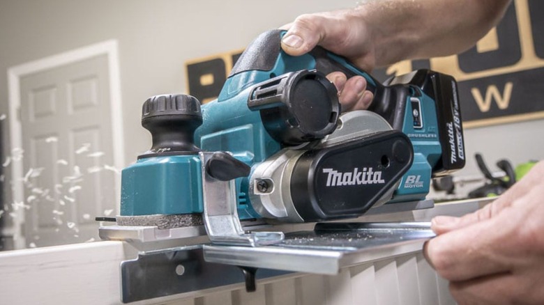 Person using a planer on wood