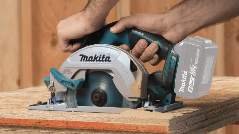 Circular saw cutting through wood