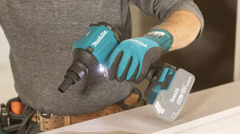 Person using a small blower