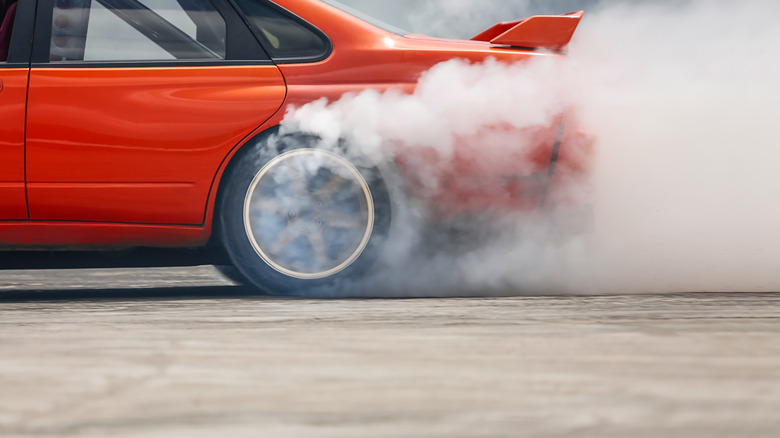 Red car spins the back wheels to 