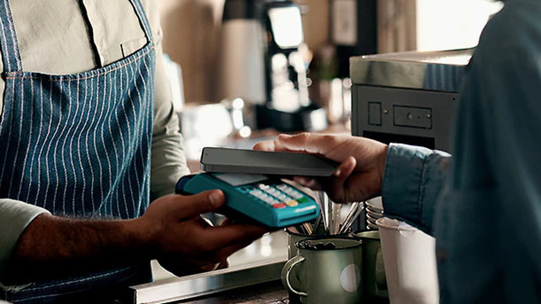 Person using Samsung Wallet at coffee shop