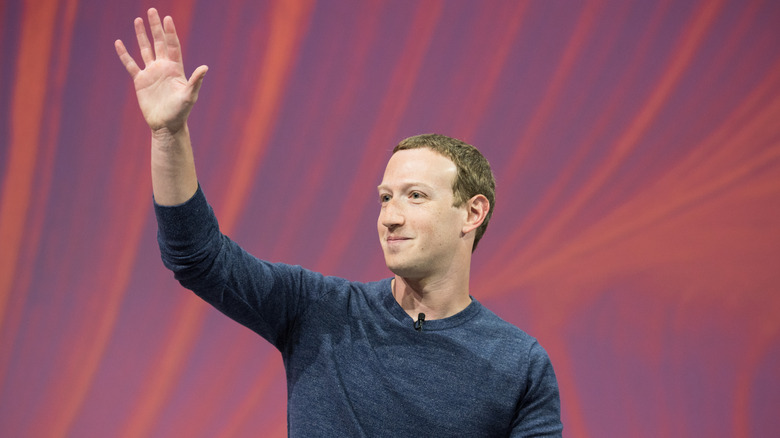 Mark Zuckerberg waving at a crowd.