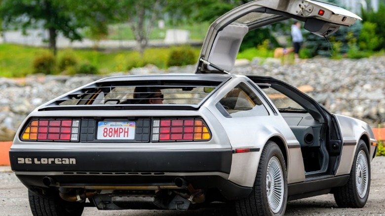 Silver DeLorean with gullwing door open