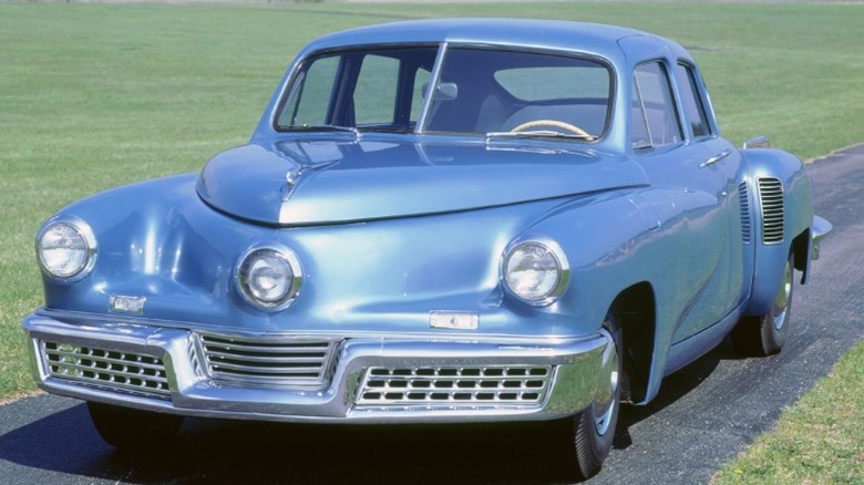 Blue 1948 Tucker driving in the country