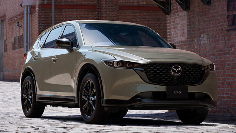 Front 3/4 view of 2023 Mazda CX-5 in city setting
