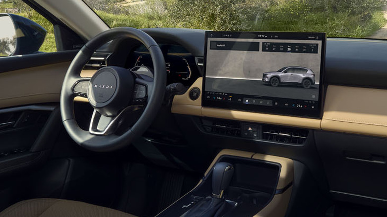 2026 Mazda CX-5 interior showing touchscreen, steering wheel, and instrument panel