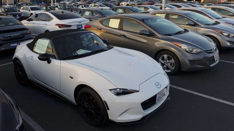Overhead view of white Mazda MX-5 Miata parked on CarMax dealer lot.