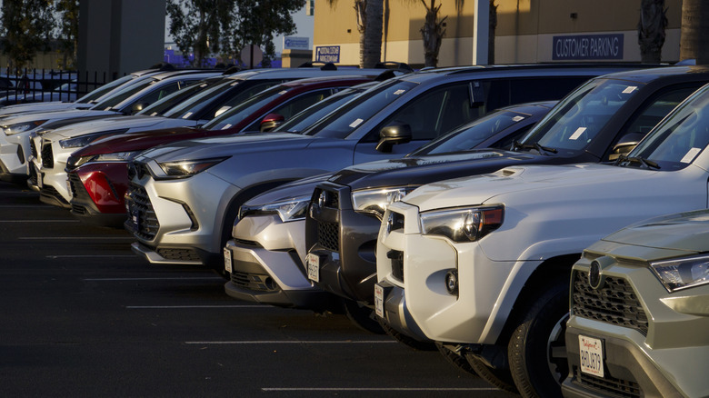 A line of used Toyota models parked at a CarMax dealership.