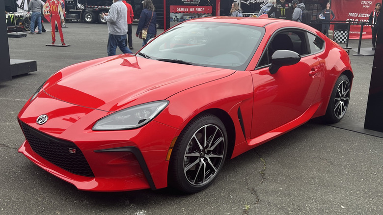 Front 3/4 view of red Toyota GR86 on display at Sonoma Raceway.